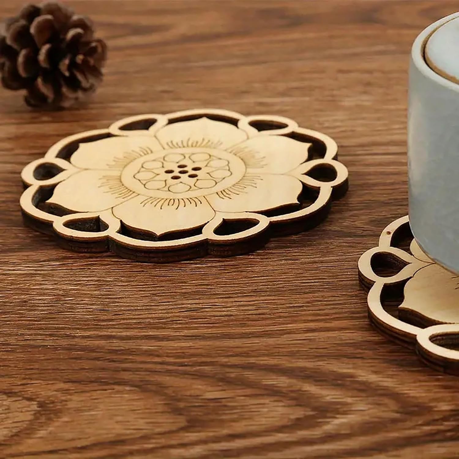 Wooden coaster with floral design on a wooden surface
