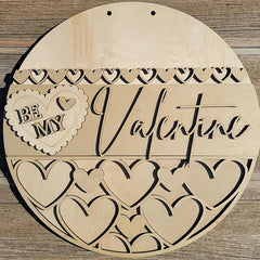 Wooden heart-shaped sign with 'Be My Valentine' text on a wooden background