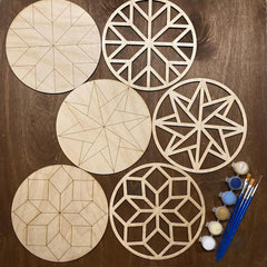 Set of wooden geometric shapes with paint and brushes on a wooden surface