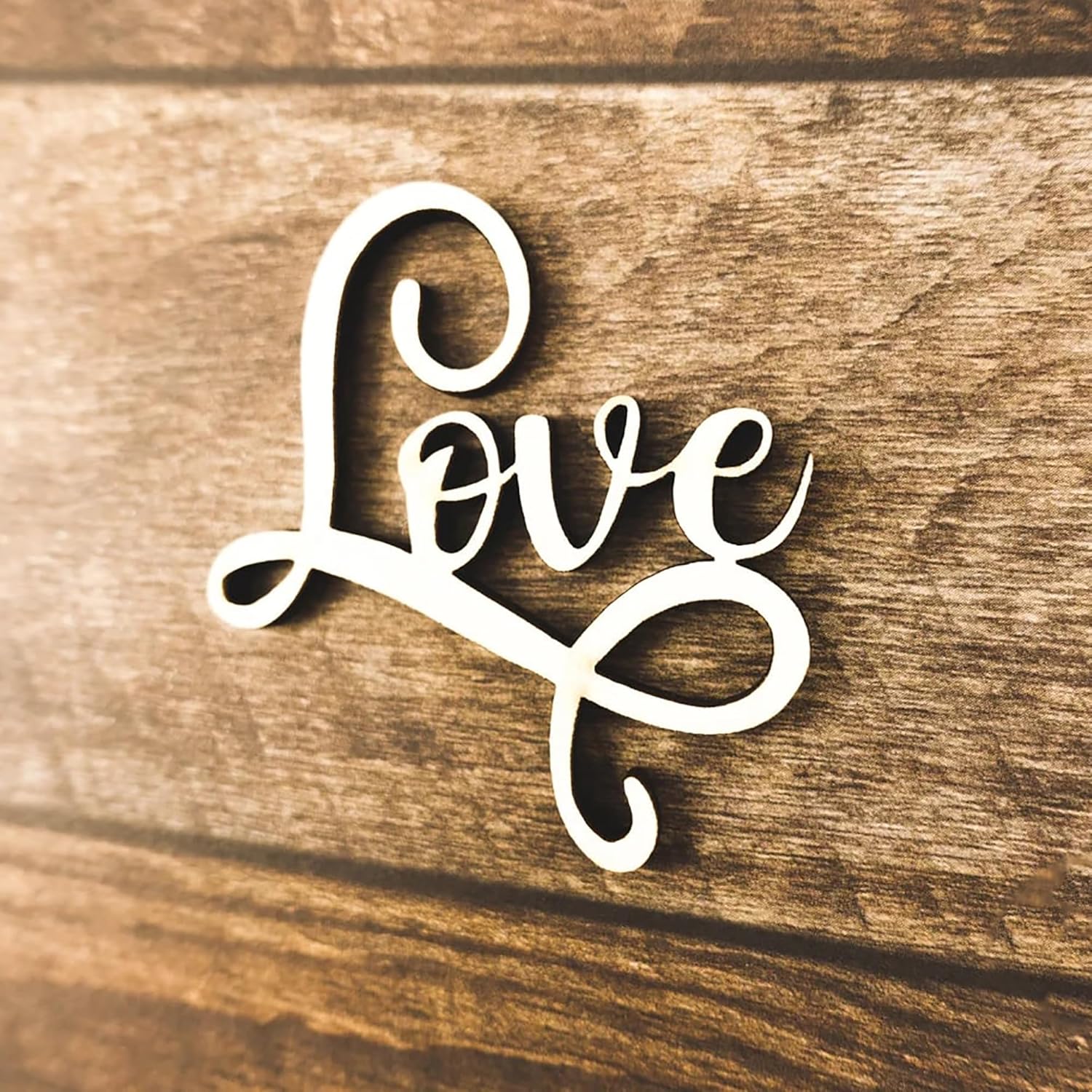 Wooden decorative piece with 'Love' text on a wooden background