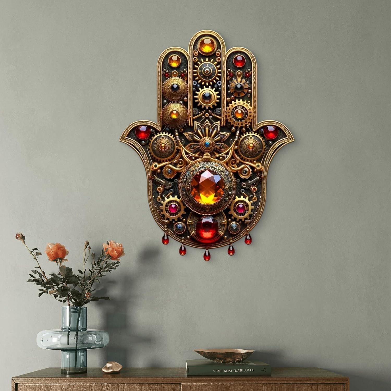Decorative wall art of a hand with gemstones on a gray wall.