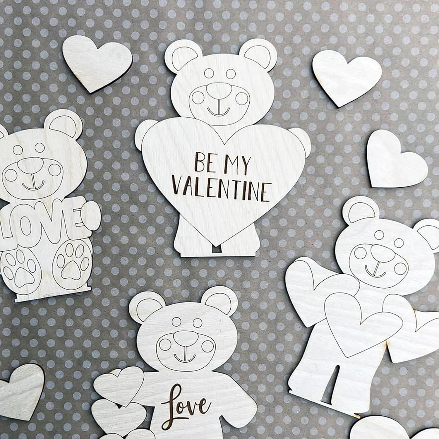 White teddy bear and heart cutouts with 'Be My Valentine' and 'Love' text on a gray background.