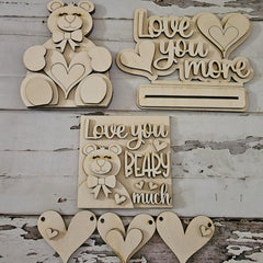 Wooden decorative items with 'Love you more' and 'Love you BEARY much' text on a rustic wooden background.