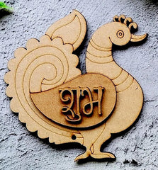 Wooden decorative item shaped like a peacock with 'Shubh' engraving on a textured surface