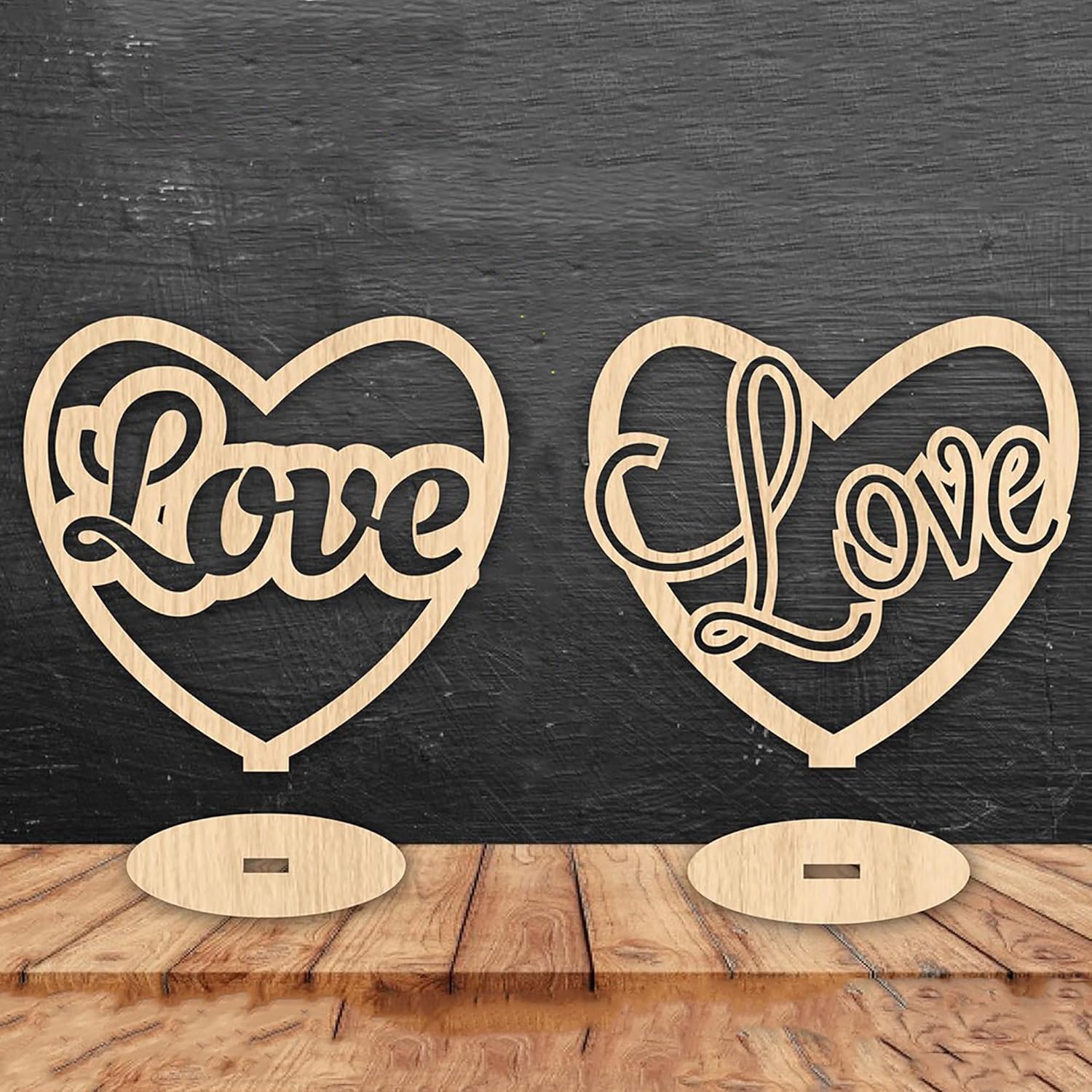 Two wooden heart-shaped signs with 'Love' engraved on them against a dark wooden background.
