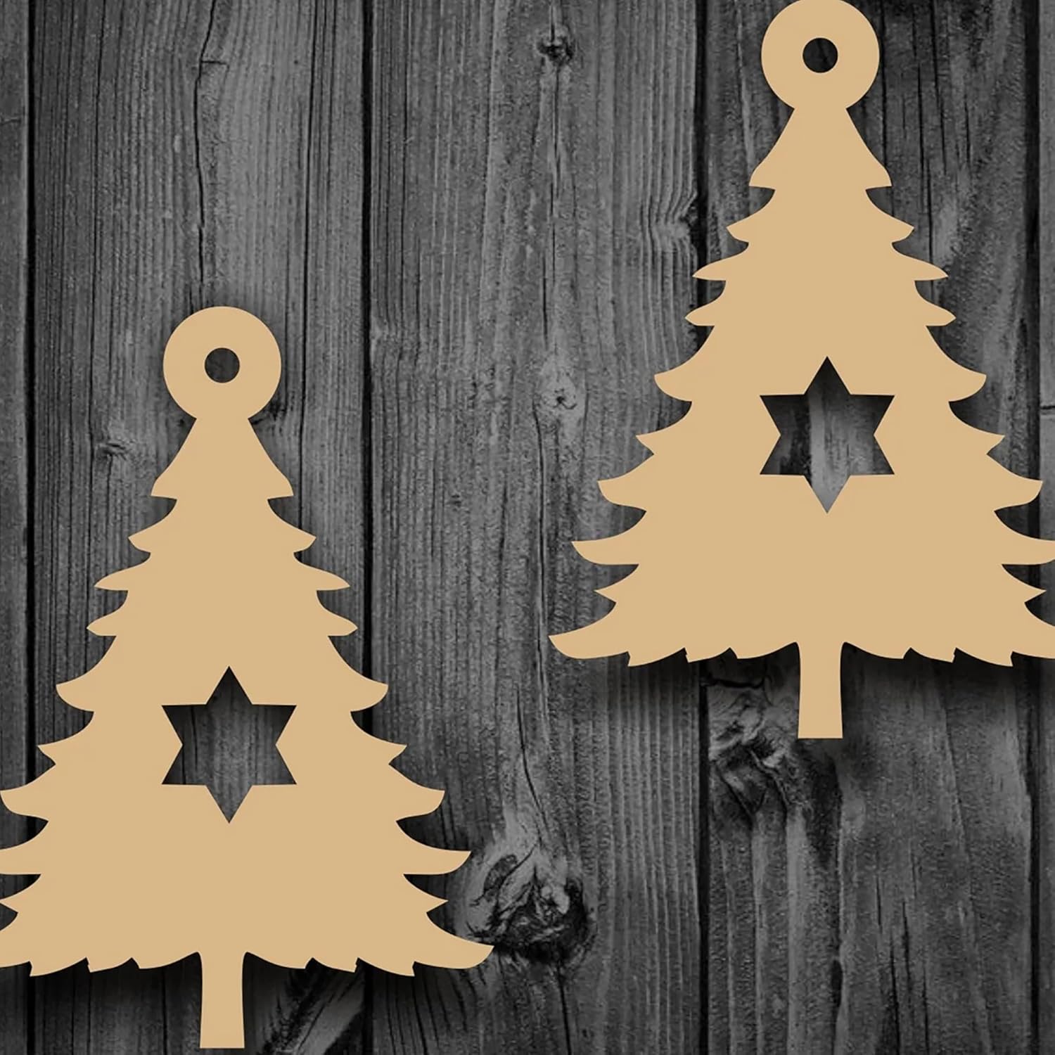 Two beige Christmas tree-shaped cutouts with star cutouts on a wooden background