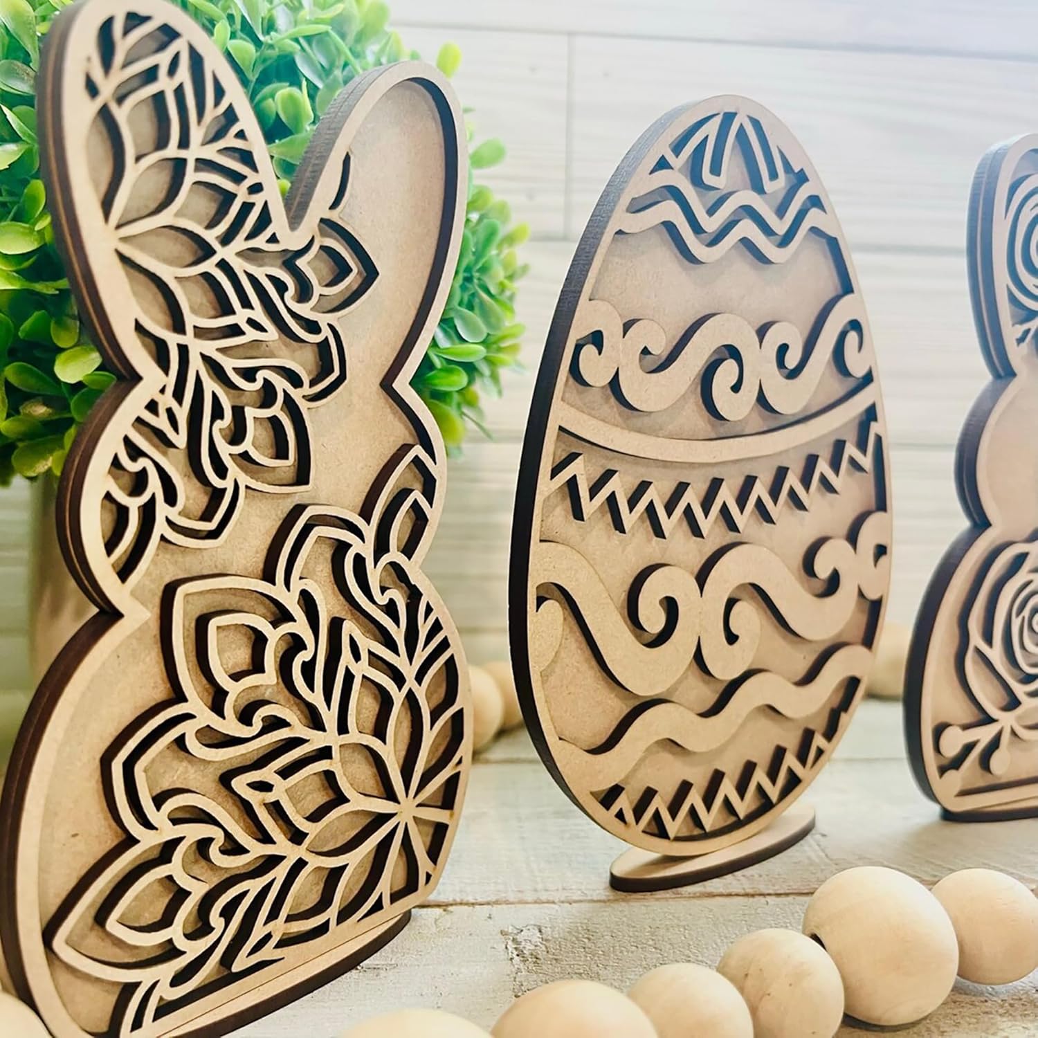 Wooden Easter decorations including a bunny and eggs on a light background.