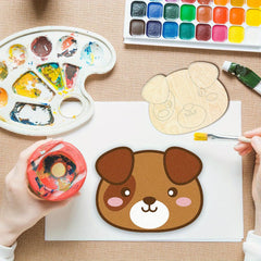 Artistic depiction of a dog's face being painted on a white sheet with a palette and watercolor set in the background.