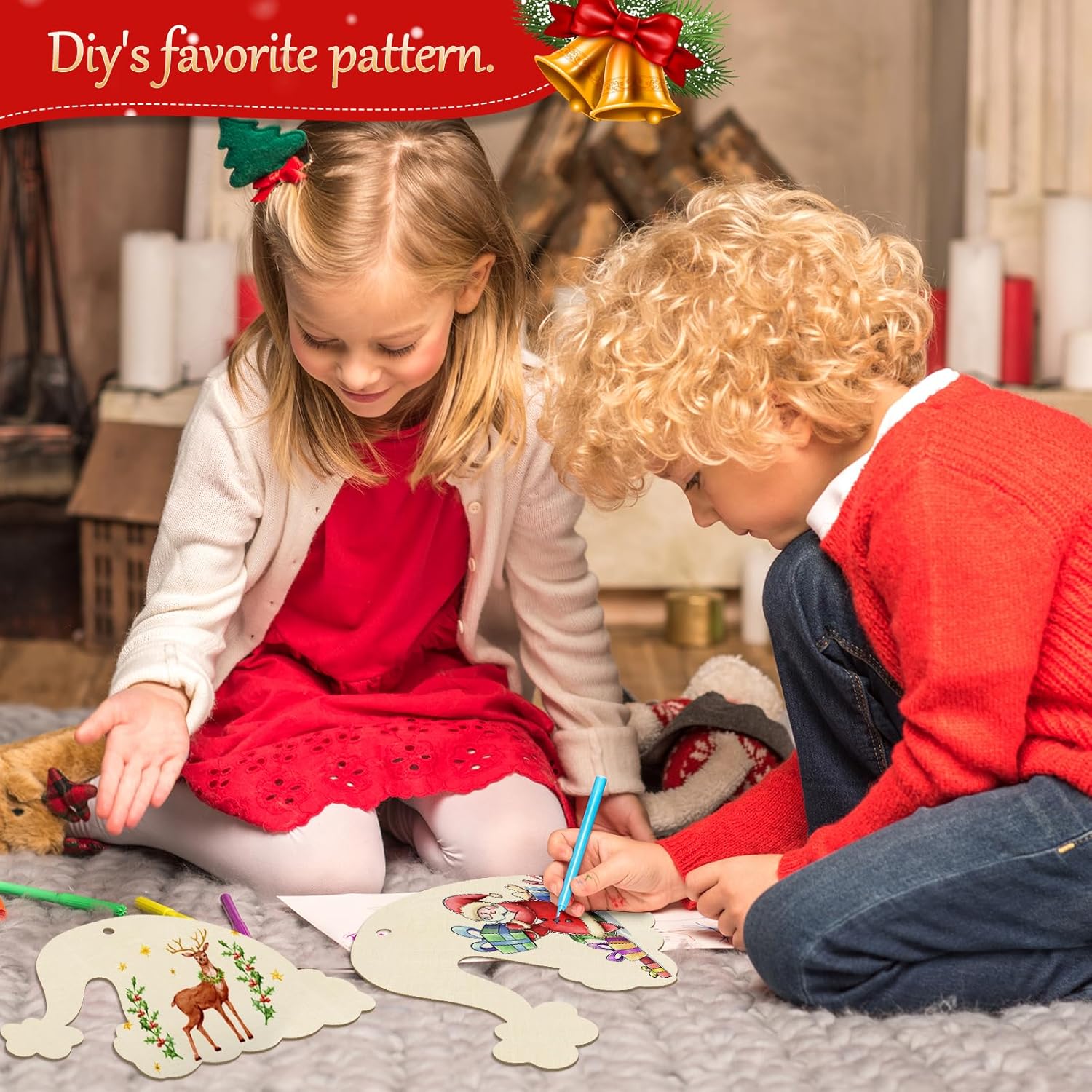 Two children sitting on a rug, engaged in a craft activity with Christmas-themed decorations.