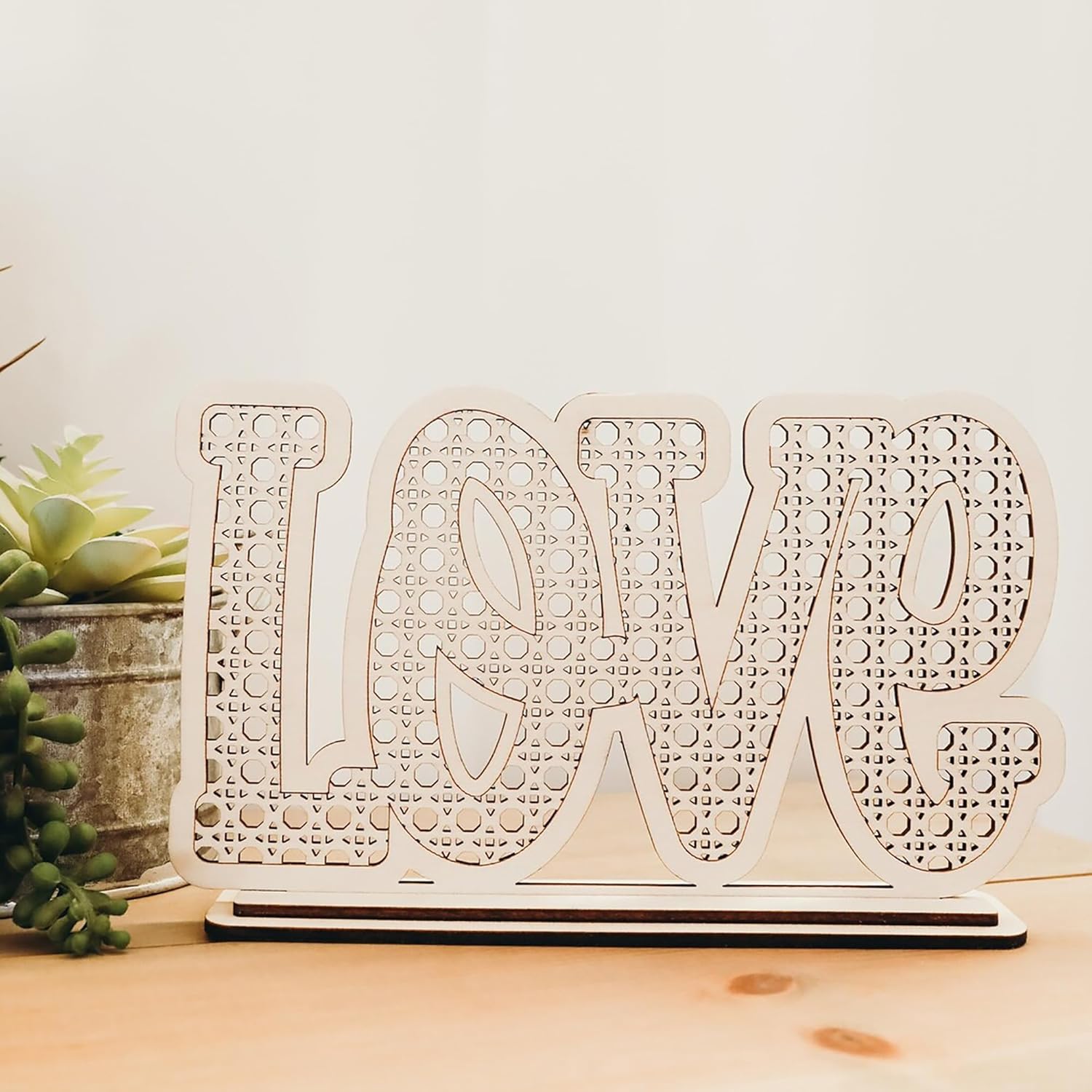 Decorative wooden letters spelling 'LOVE' on a light background