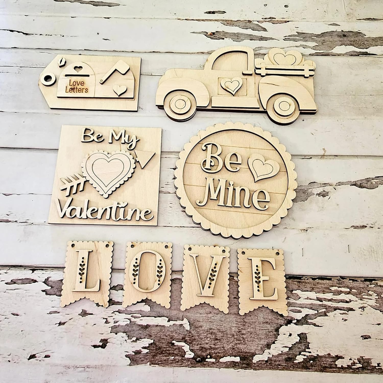 Wooden decorative items with romantic phrases on a rustic wooden background