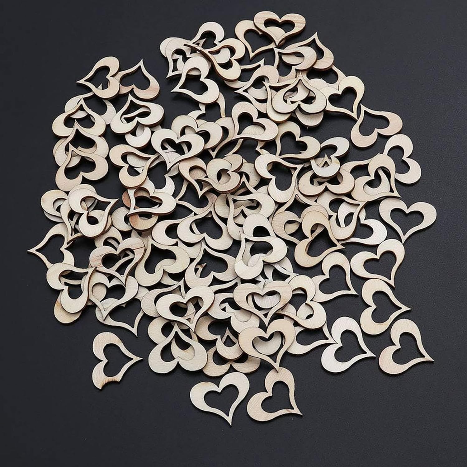 Wooden heart-shaped cutouts on a black background