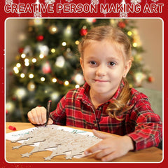 Child making art with a Christmas tree in the background