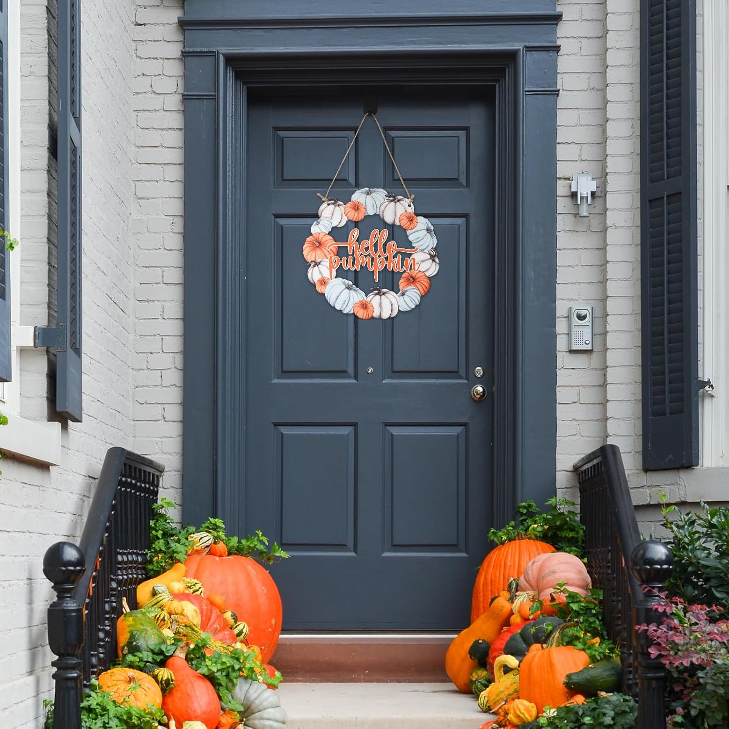 Decorative wreath with pumpkins on a blue door of a house