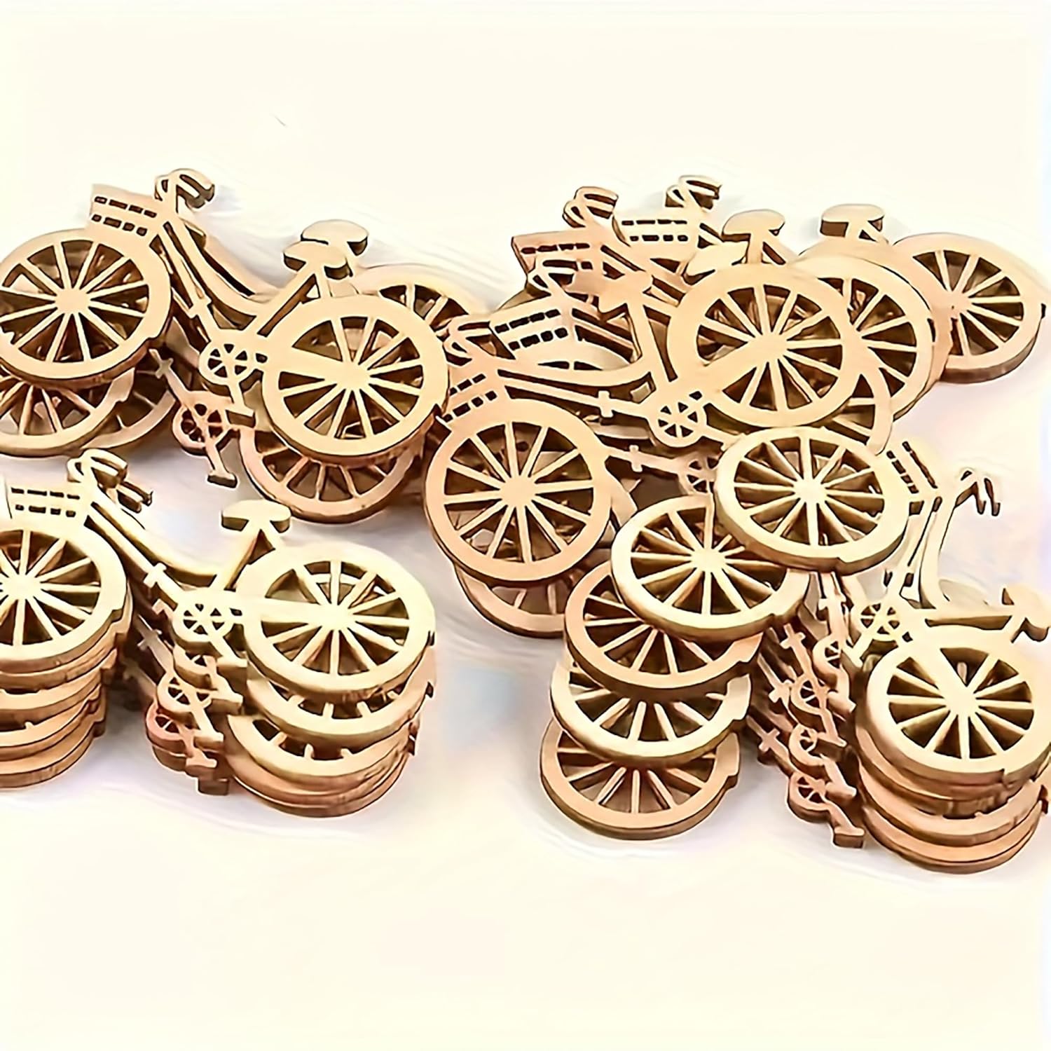 Stack of wooden bicycle-shaped cutouts on a white background