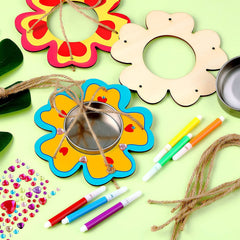 Colorful craft materials including flower-shaped frames, markers, beads, and string on a light green background.