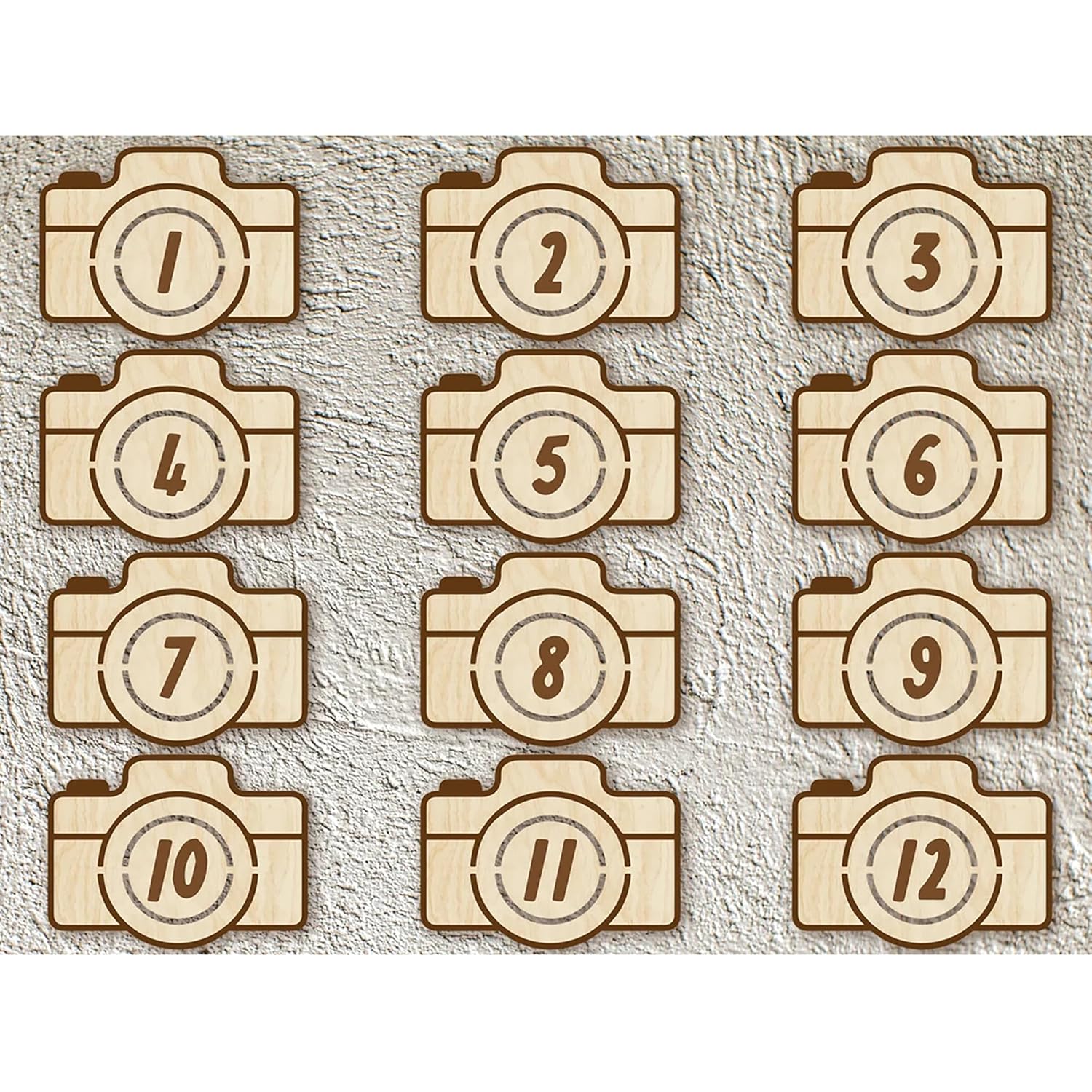 Wooden camera-shaped numbers from 1 to 12 on a textured beige background