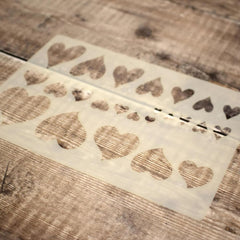 Wooden stamp with heart designs on a wooden surface