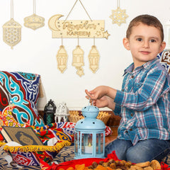 Child playing with a lantern next to Ramadan decorations and food.