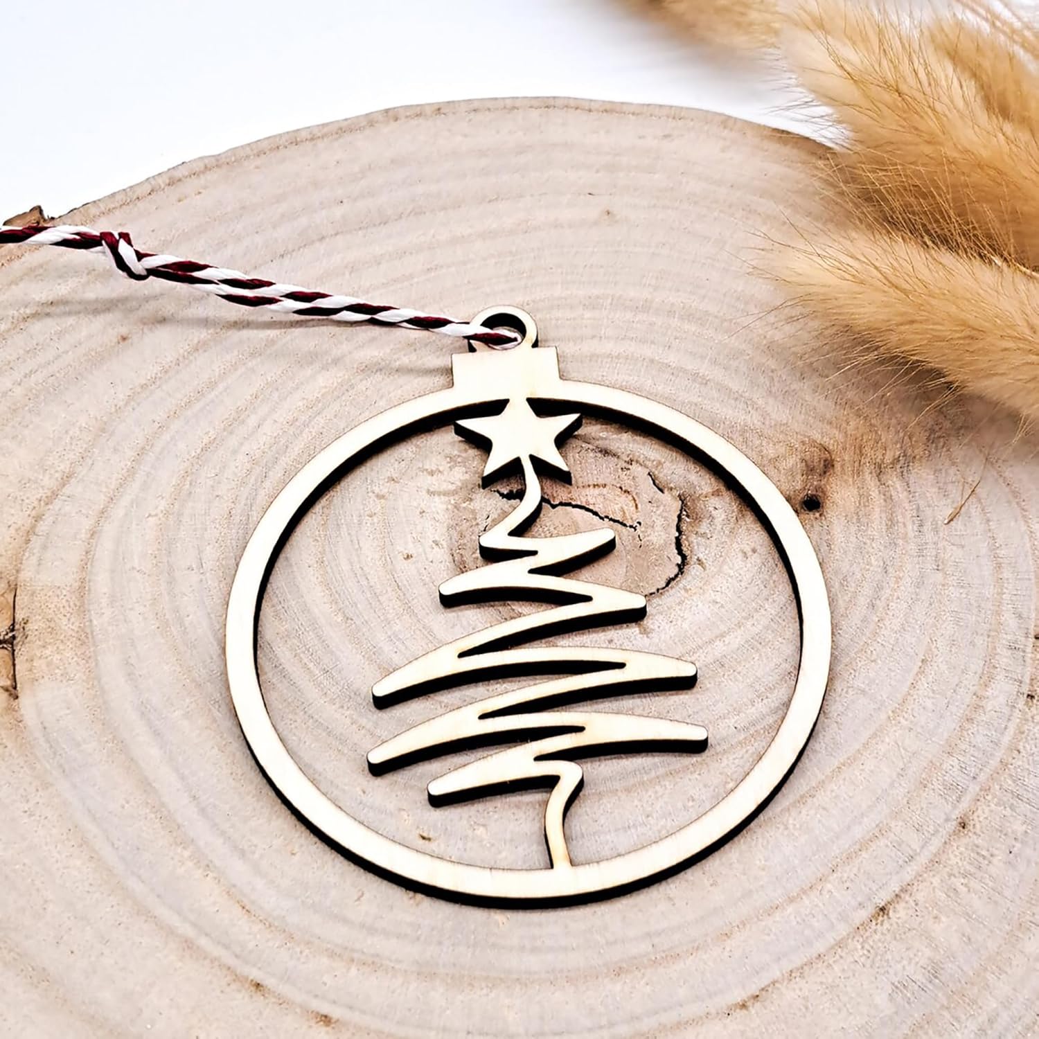 Decorative Christmas tree ornament with a star on a wooden surface