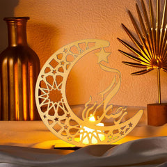 Decorative wooden moon and star lamp with a warm glow, surrounded by decorative items.