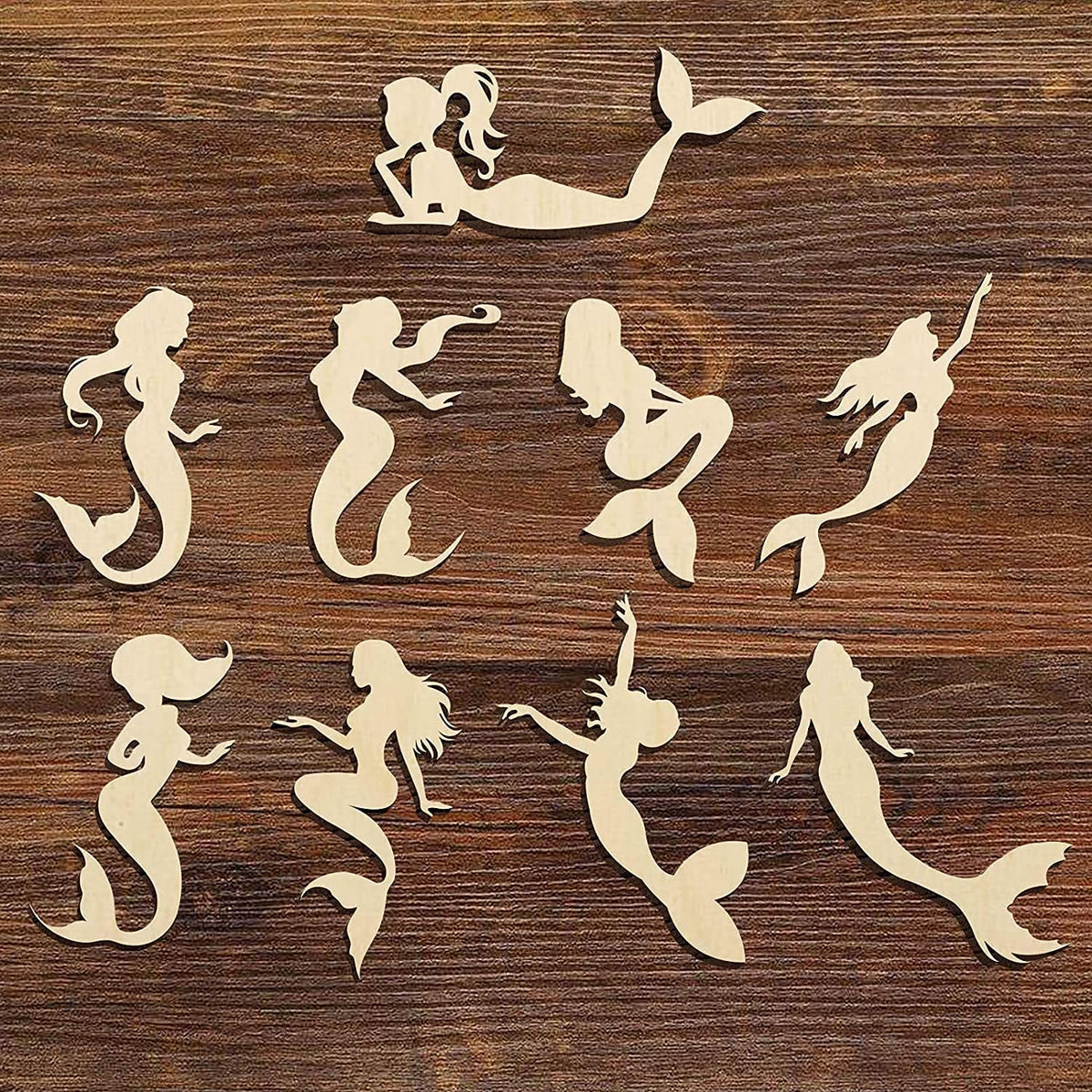 Silhouettes of mermaids on a wooden surface