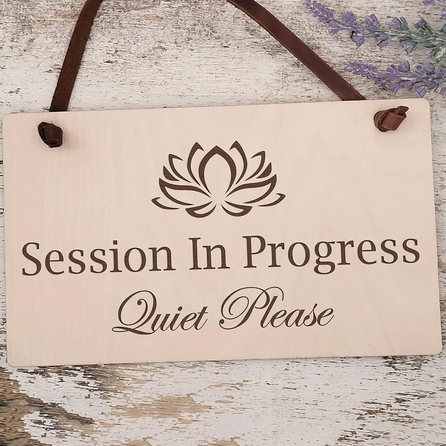 Sign with a lotus flower symbol and text 'Session In Progress Quiet Please' on a wooden background.