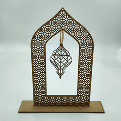 Decorative metal frame with geometric design and hanging ornament on a white background