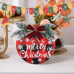 Decorative Christmas sign with plaid pattern and 'Merry Christmas' text, surrounded by festive decorations.