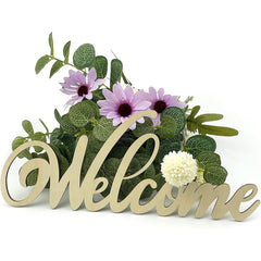 Decorative 'Welcome' sign with flowers and greenery on a white background