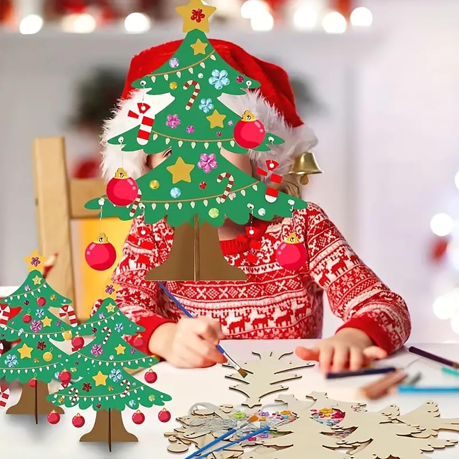 Child in festive clothing making a Christmas tree craft with decorations.