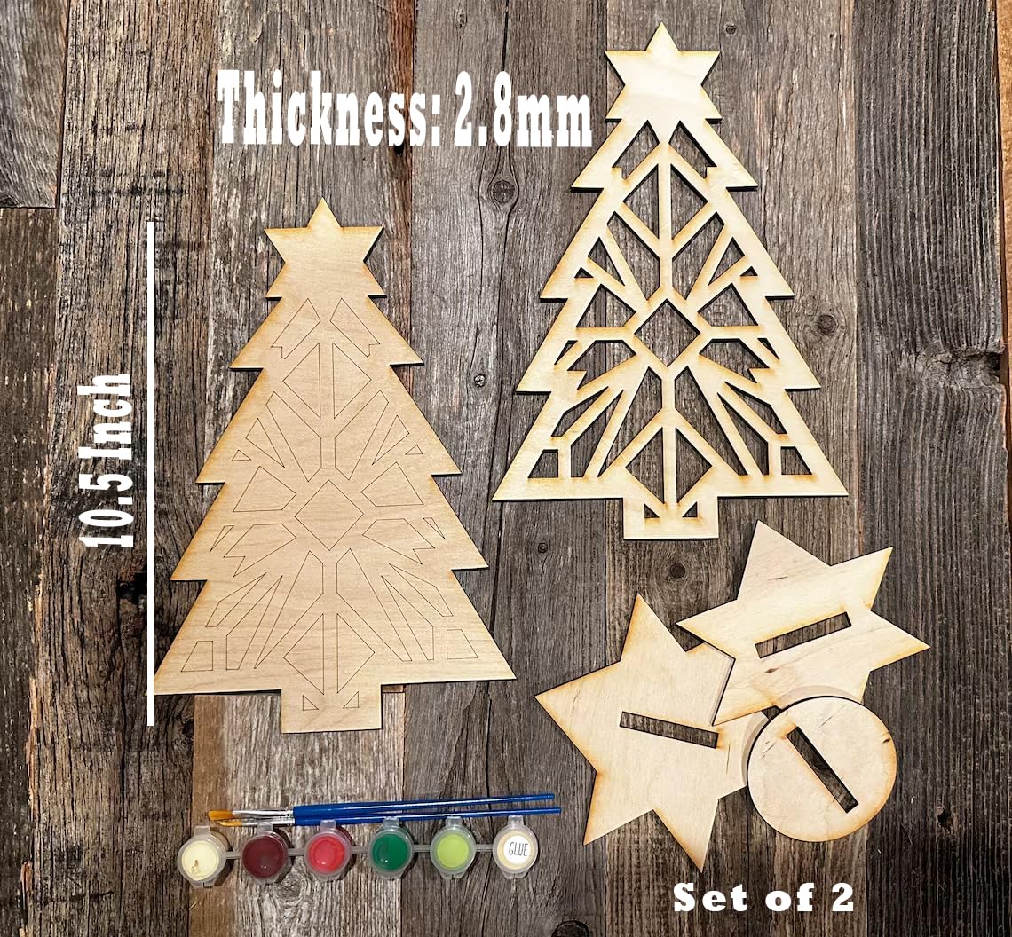 Wooden Christmas tree and star decorations with paint supplies on a wooden background