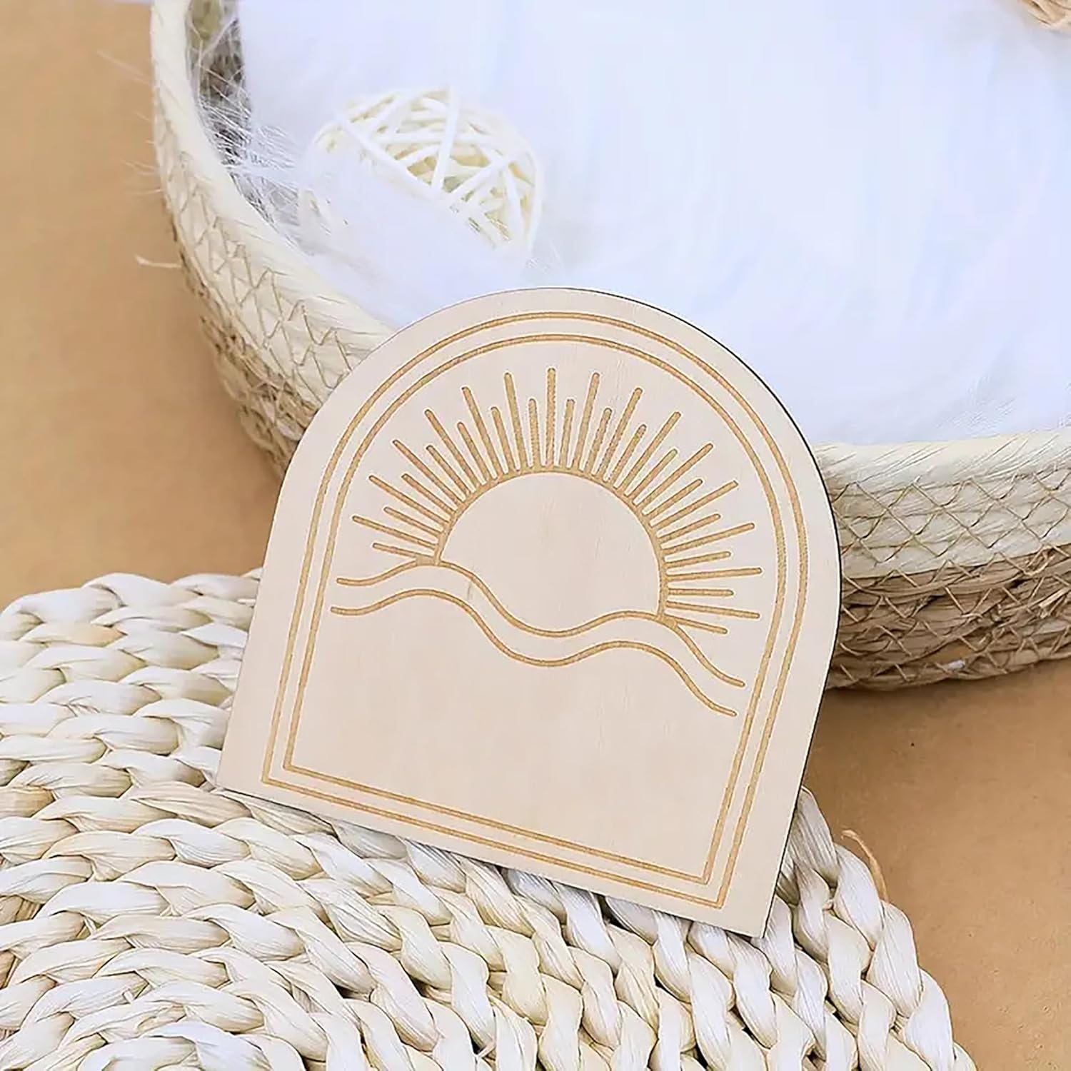 Beige card with sun and wave design on a woven surface