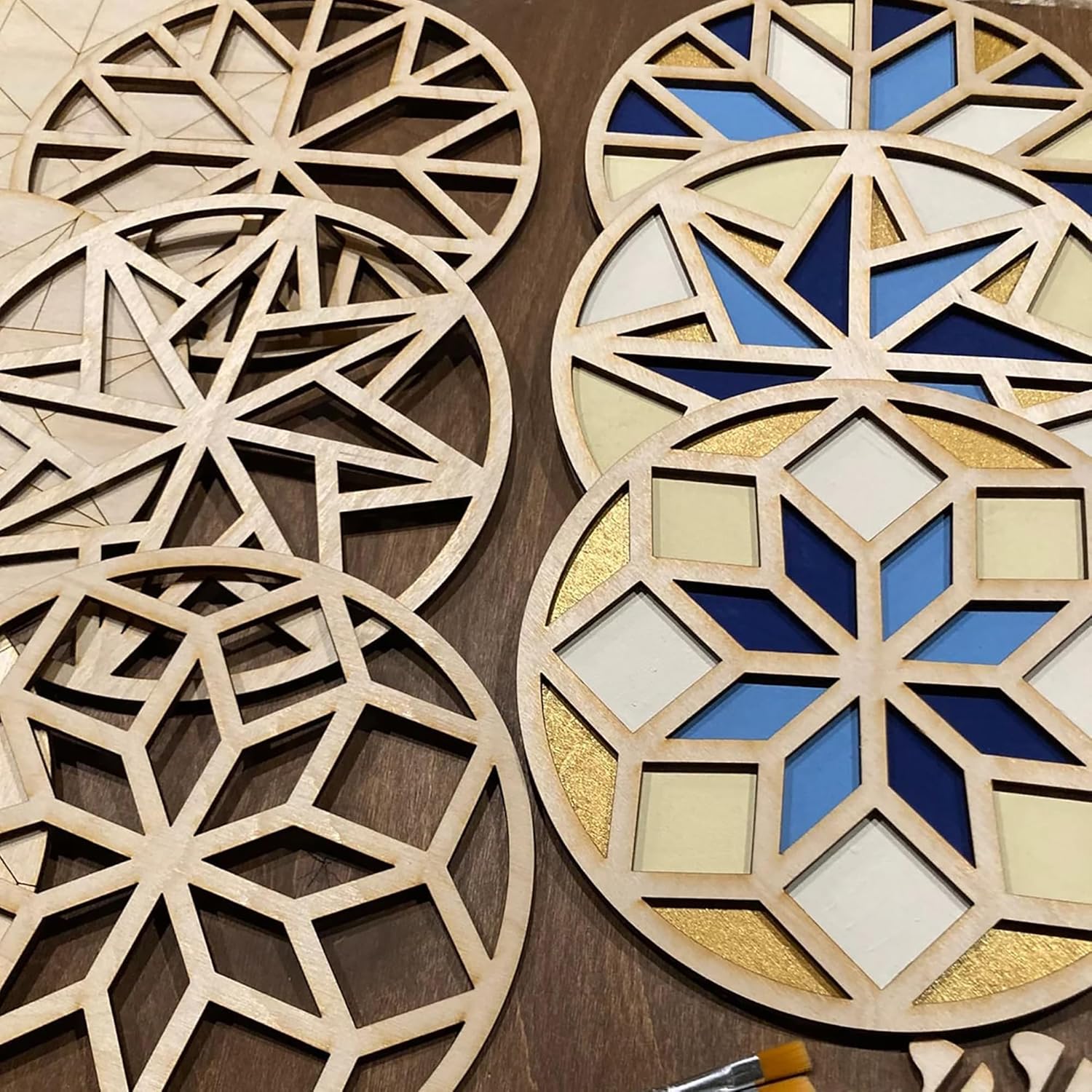Decorative wooden panels with geometric patterns on a wooden surface