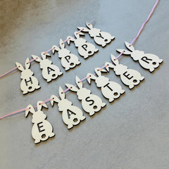 Happy Easter banner with bunny shapes on a gray background