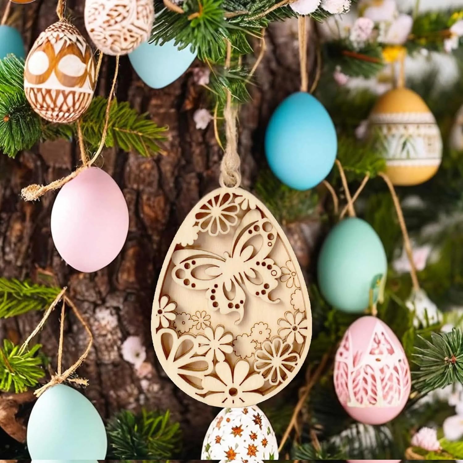 Decorative Easter egg ornaments with intricate designs hanging on a tree.