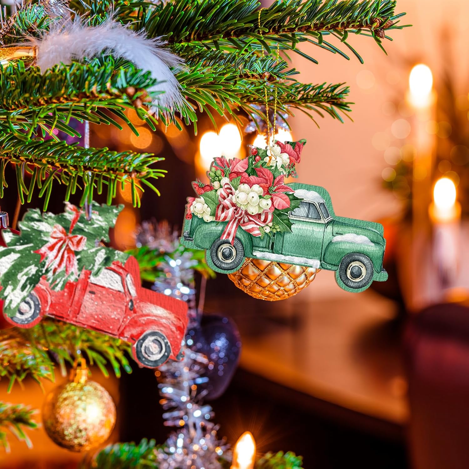 Decorative Christmas ornaments of vintage trucks on a lit Christmas tree with warm background.