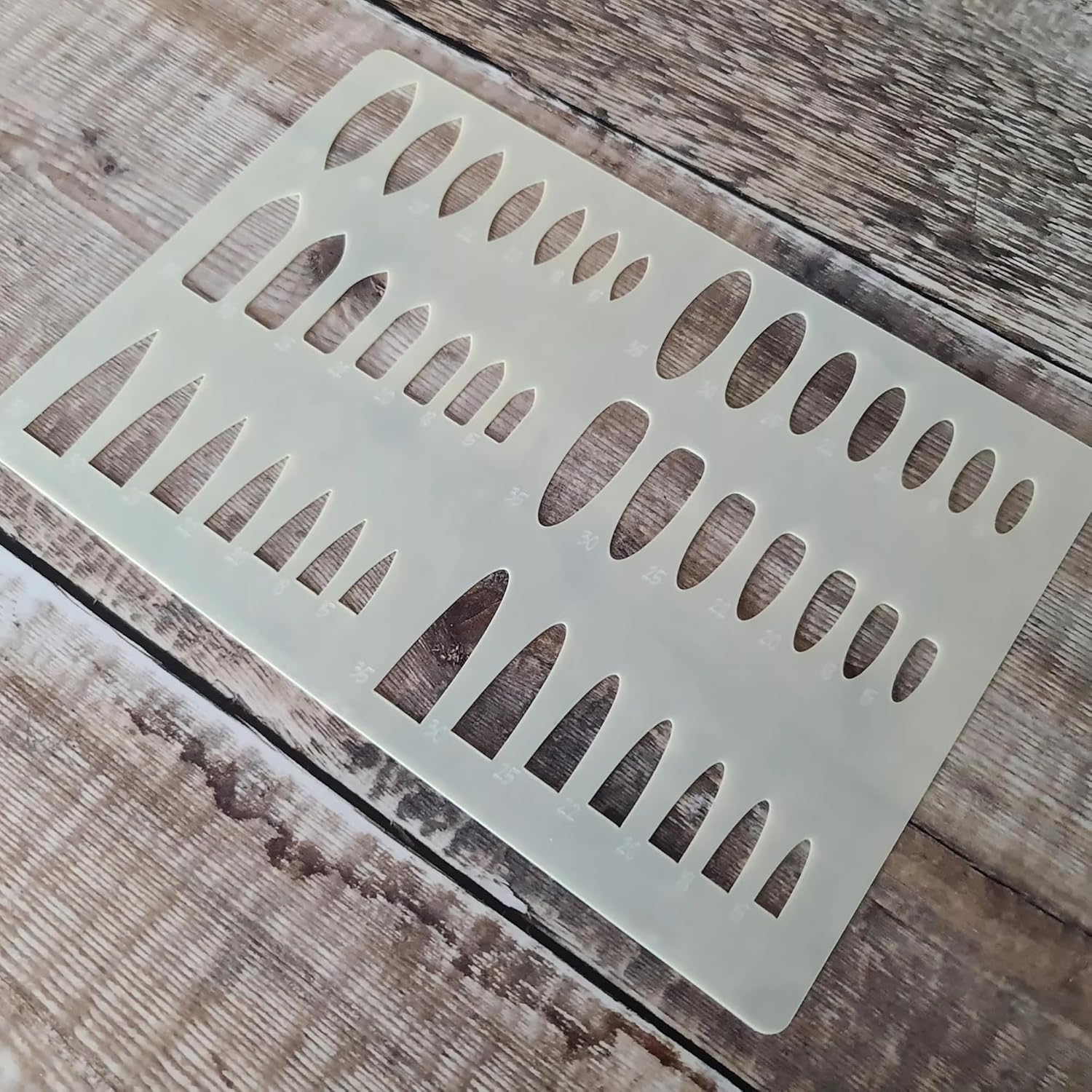 Decorative metal vent cover with cut-out design on a wooden surface