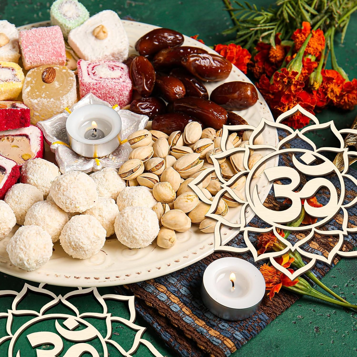 Assorted sweets, dates, and cookies on a plate with decorative elements and candles.