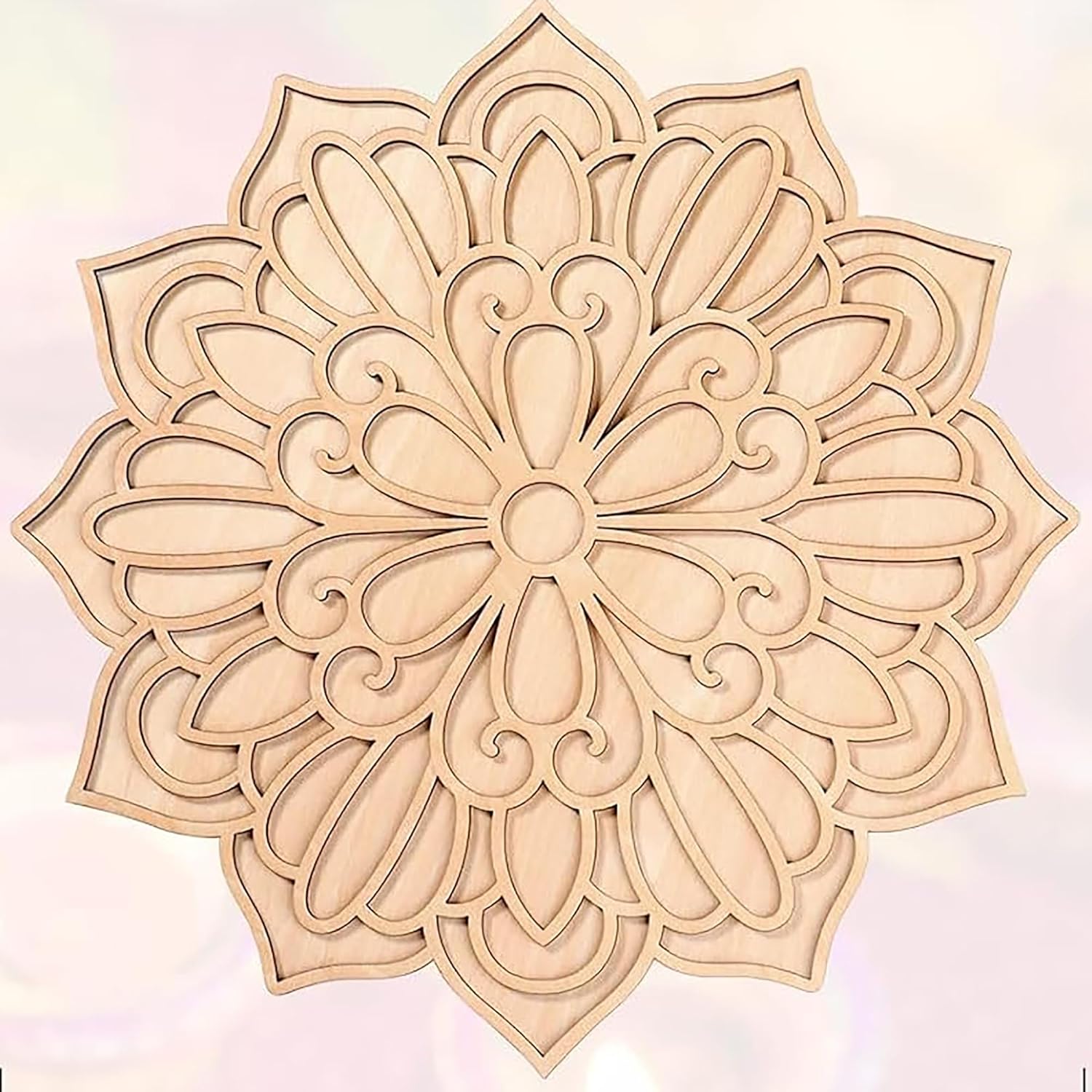 Decorative wooden mandala with intricate patterns on a light pink background