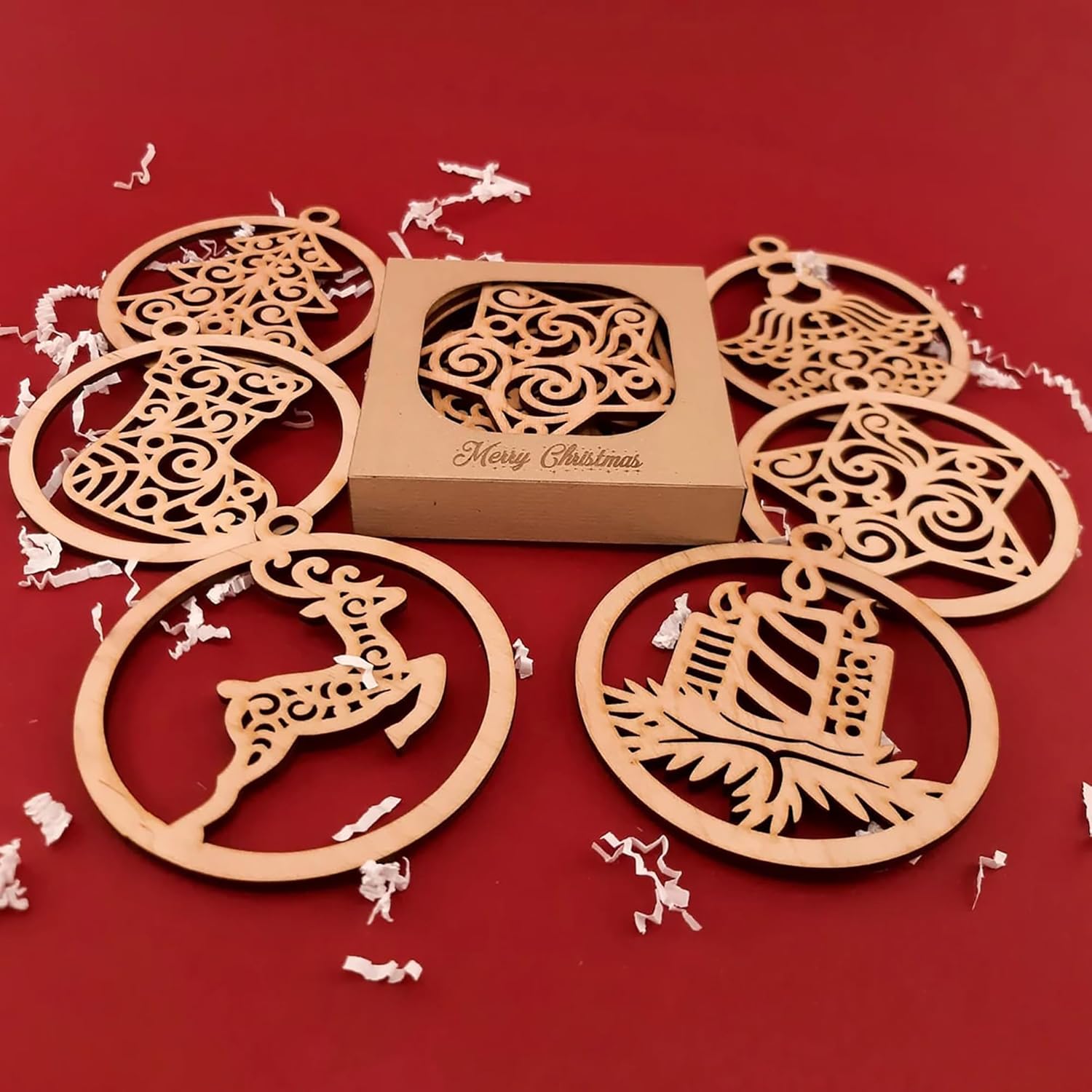 Wooden Christmas ornaments with a 'Merry Christmas' box on a red background