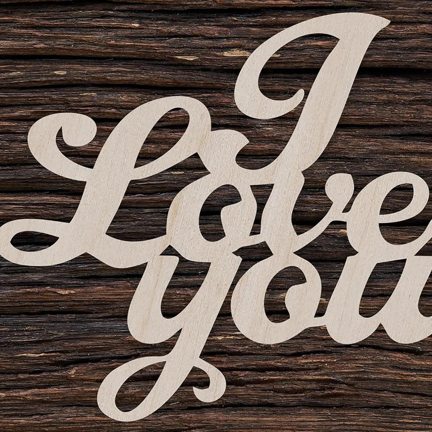 Wooden cutout letters spelling 'I love you' on a wooden background