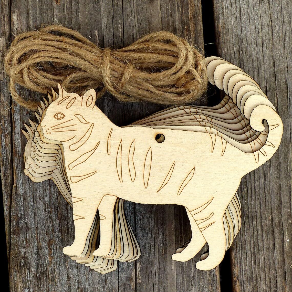 Wooden goat ornament with jute string on a wooden background