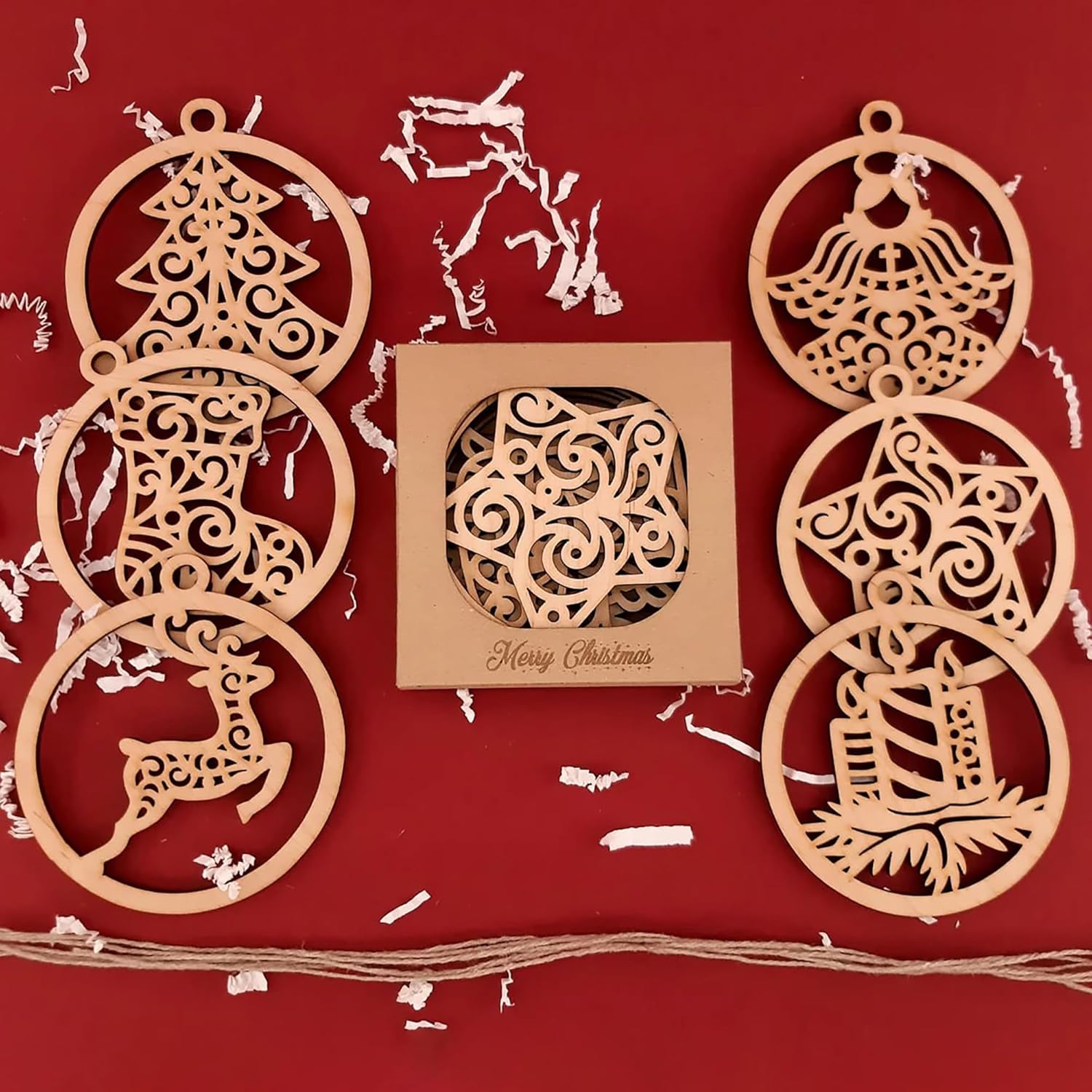 Wooden Christmas ornaments on a red background with a box of ornaments.