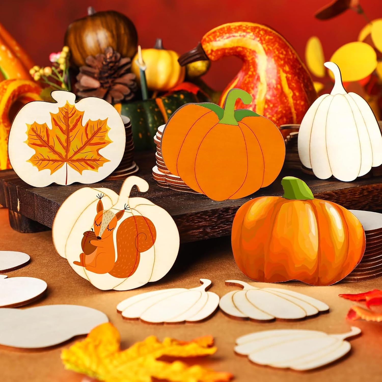 Decorative pumpkins and leaf items on a wooden surface with a warm background.