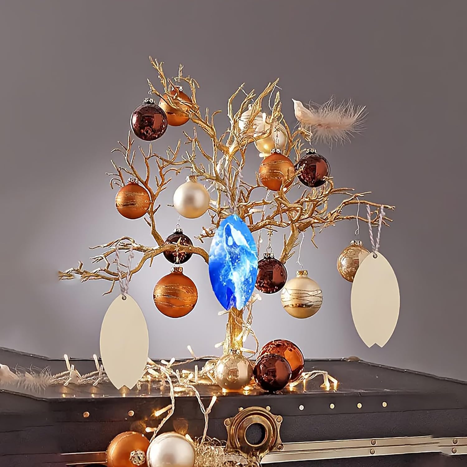 Decorative tree with ornaments and lights on a dark surface