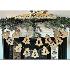 Wooden 'Merry Christmas' banner hanging on a decorated fireplace mantel.