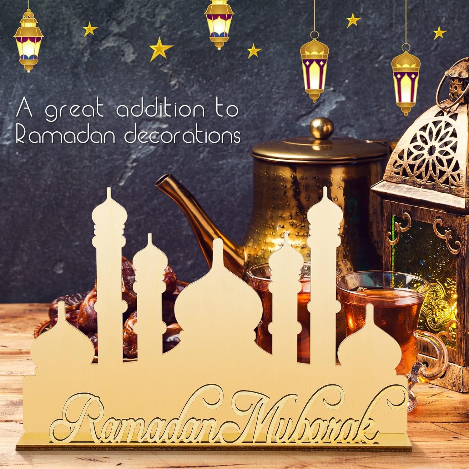 Decorative sign with 'Ramadan Mubarak' on a table with tea and lanterns, suitable for Ramadan decorations.