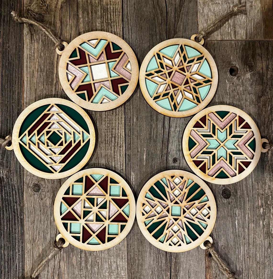 Set of six geometric wooden ornaments on a wooden background