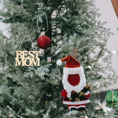 Decorative ornaments on a Christmas tree, including 'BEST MOM' and a Santa Claus figure.